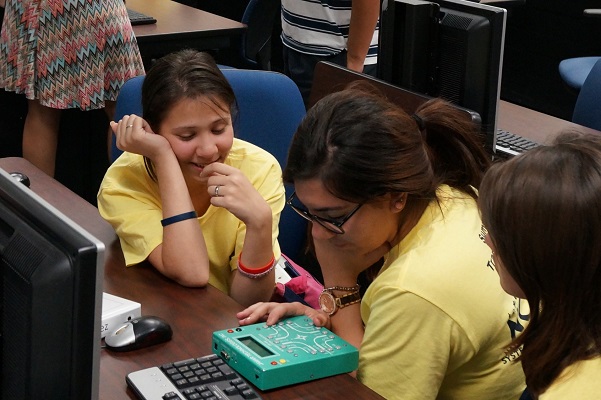 <span style="font-size:10px"> FIU students explore planning equipment at the 2014 summer camp</span>
